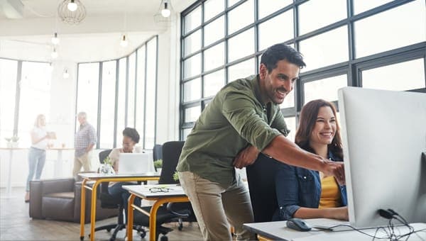 Two people working together at a computer