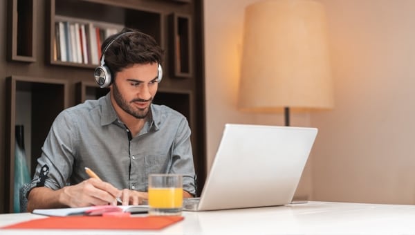 Man working while using headphones