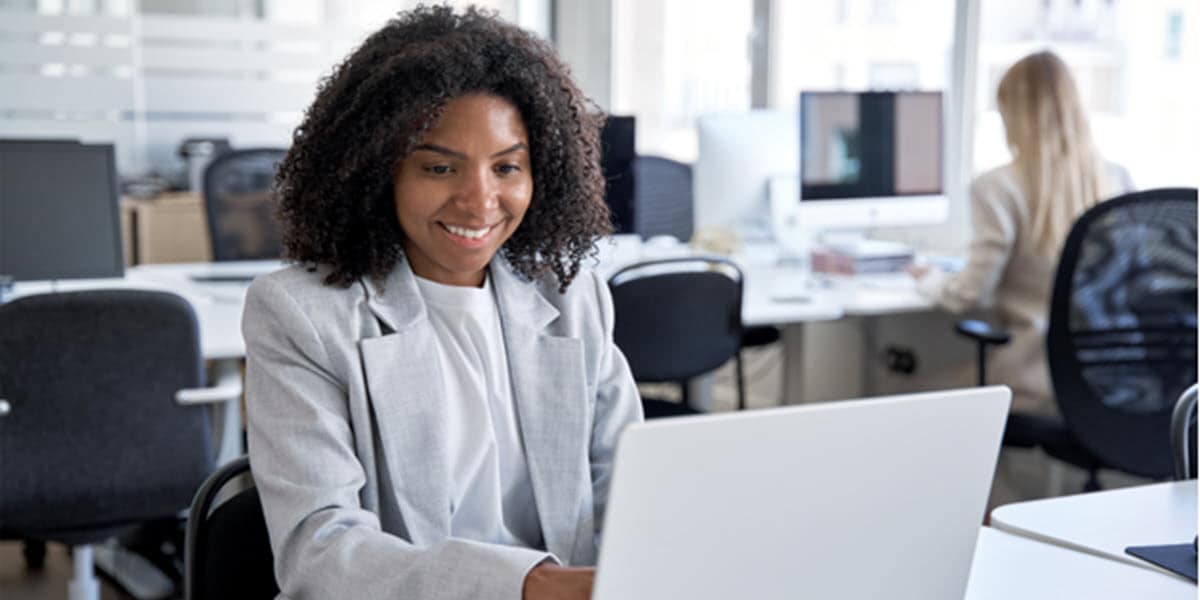 smiling woman looking at computer screen