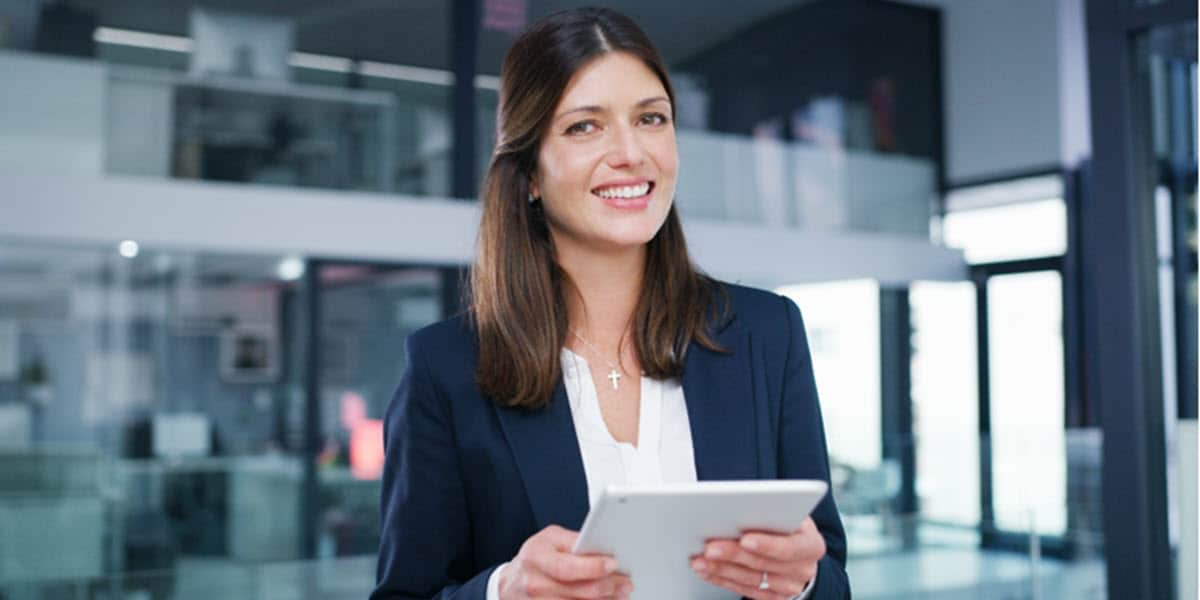 smiling woman holding tablet