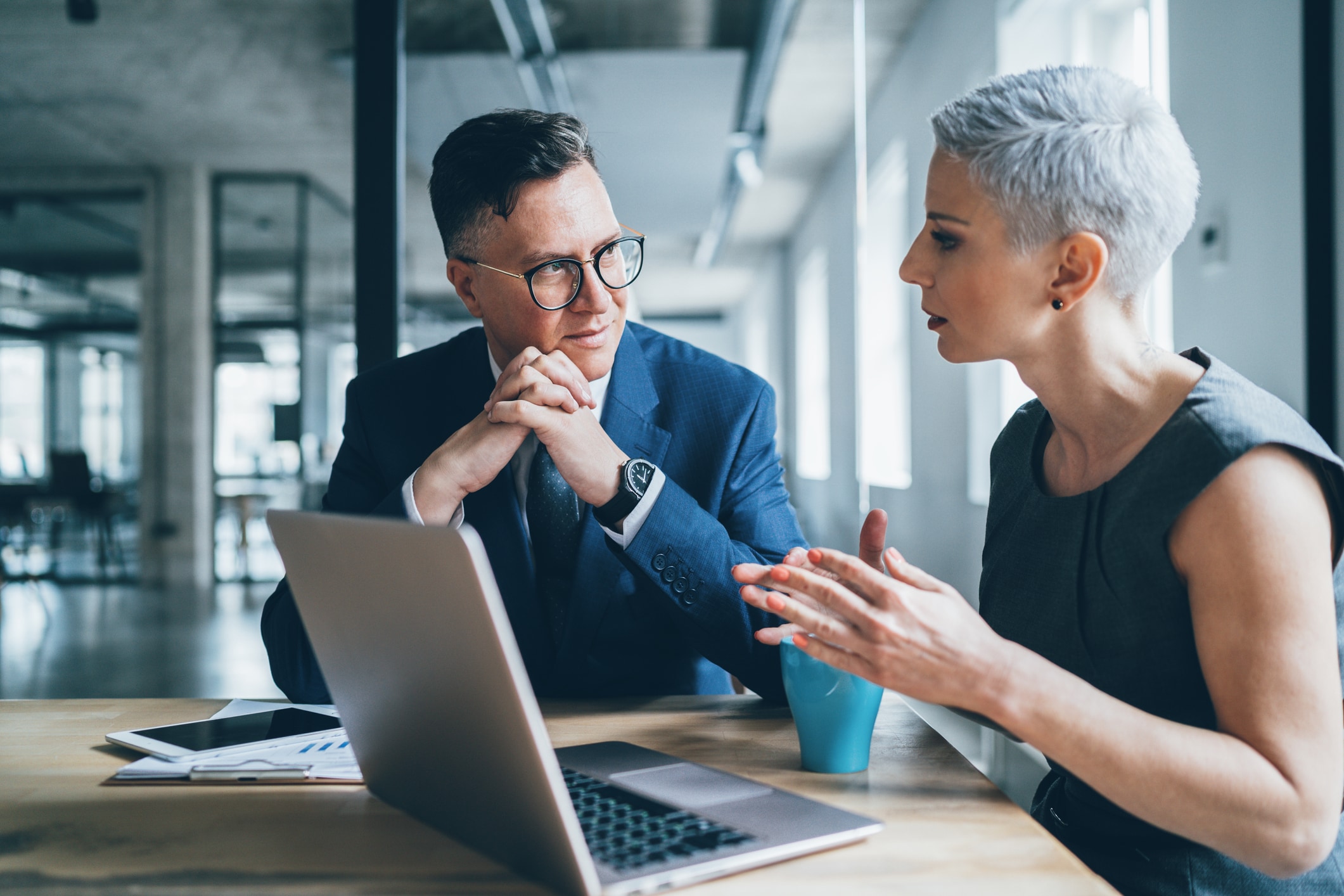 Man and woman talking at desk