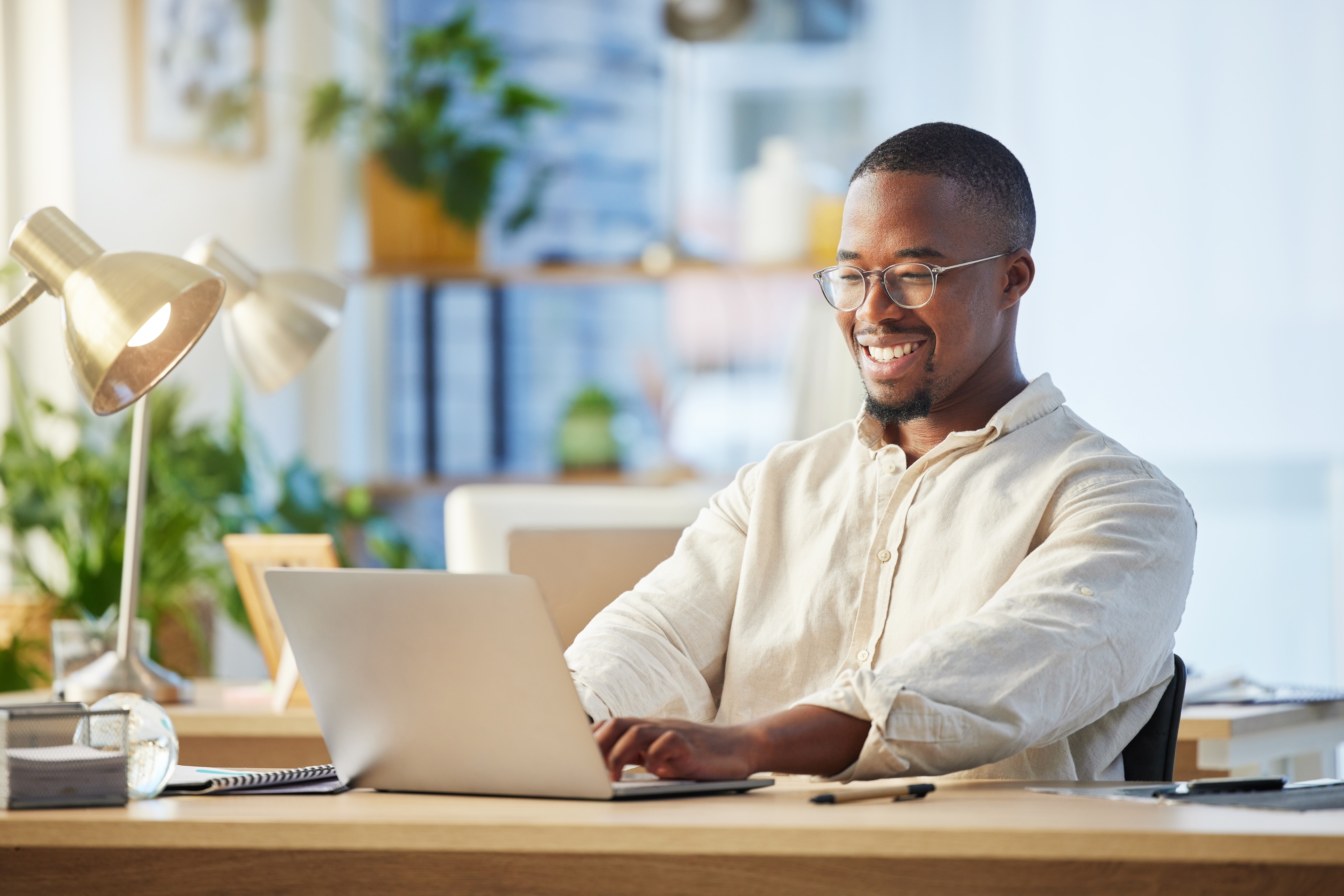 Happy AP employee working on computer