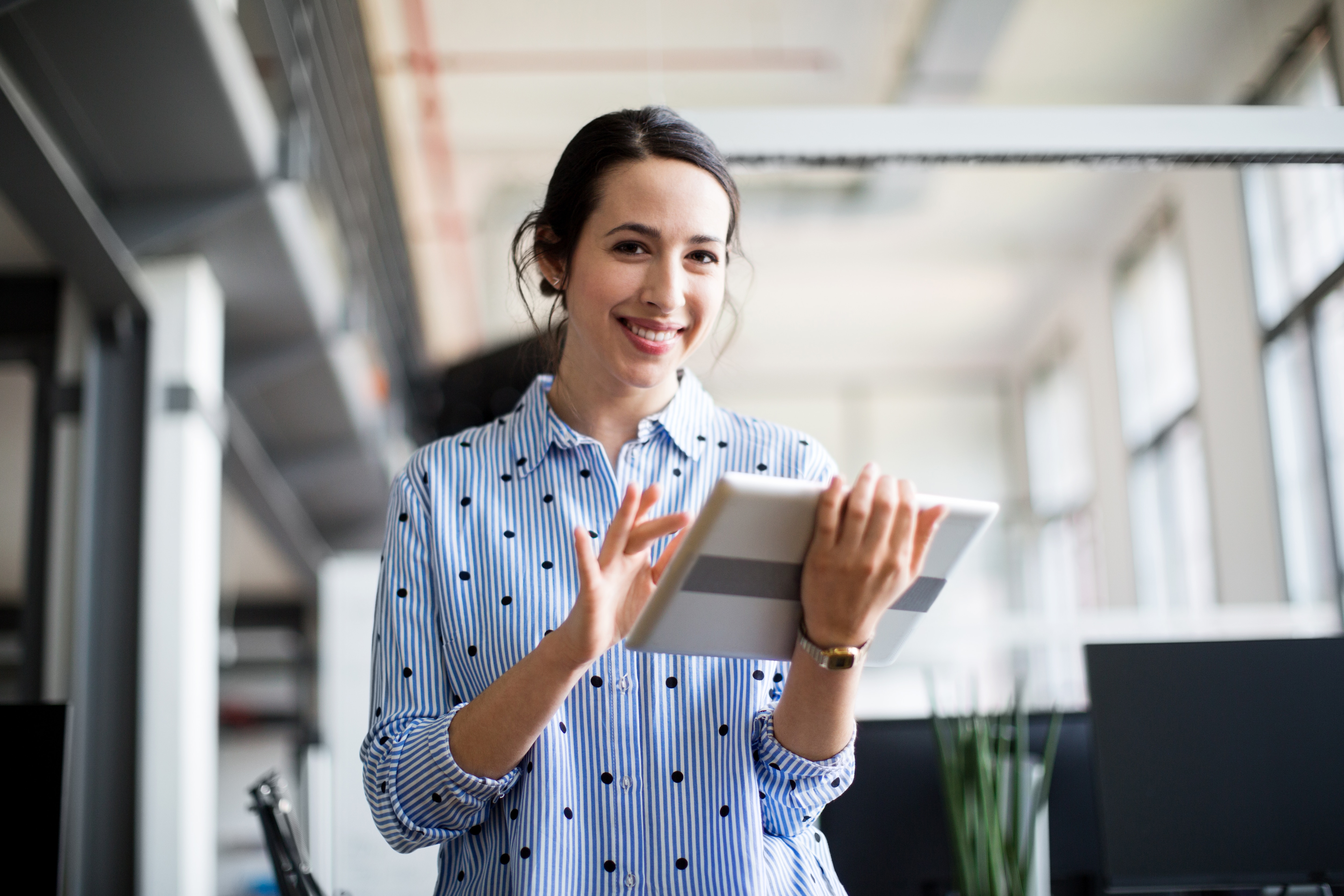 a woman holding an ipad 