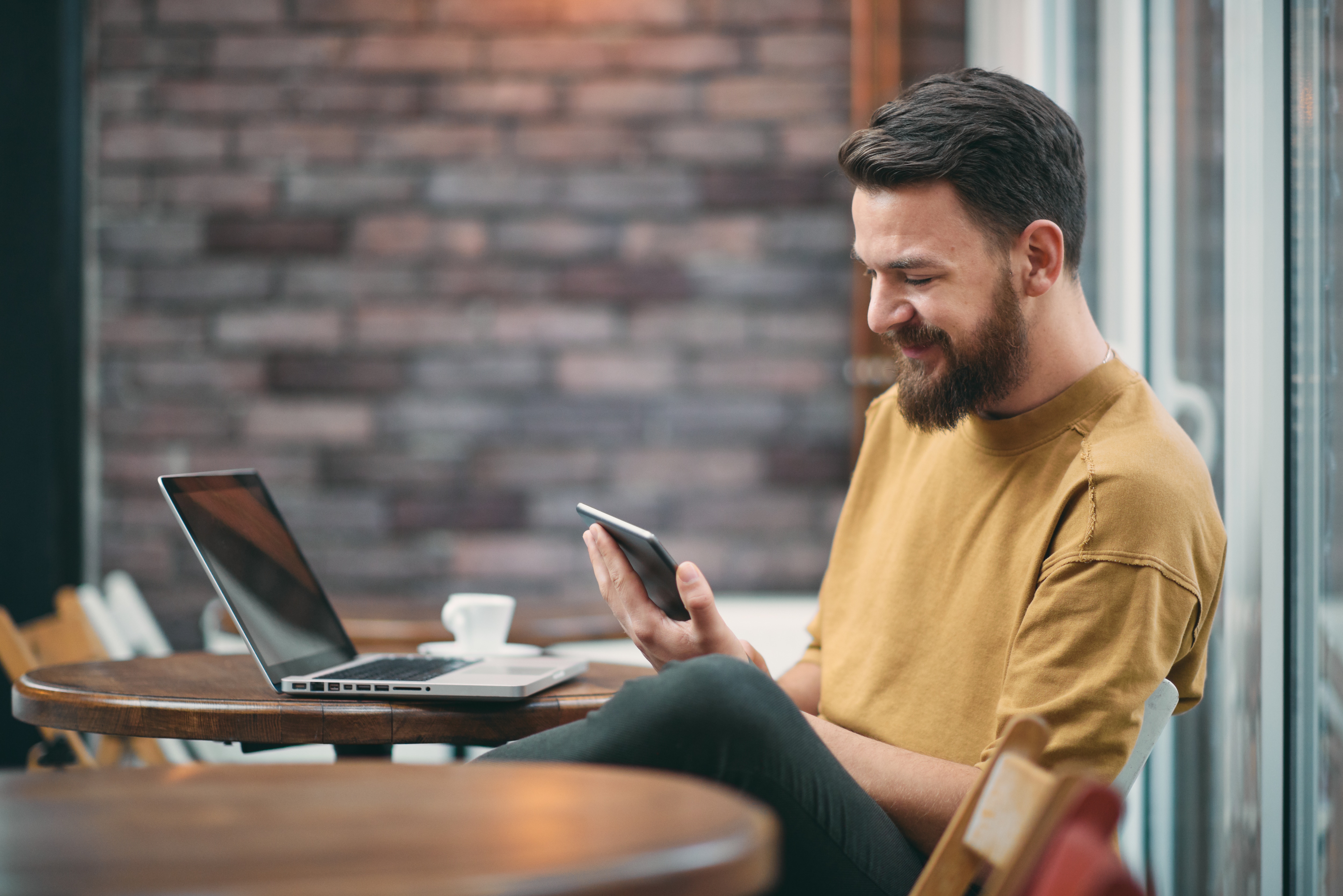 Man reading his phone about how to improve K12 school spend programs