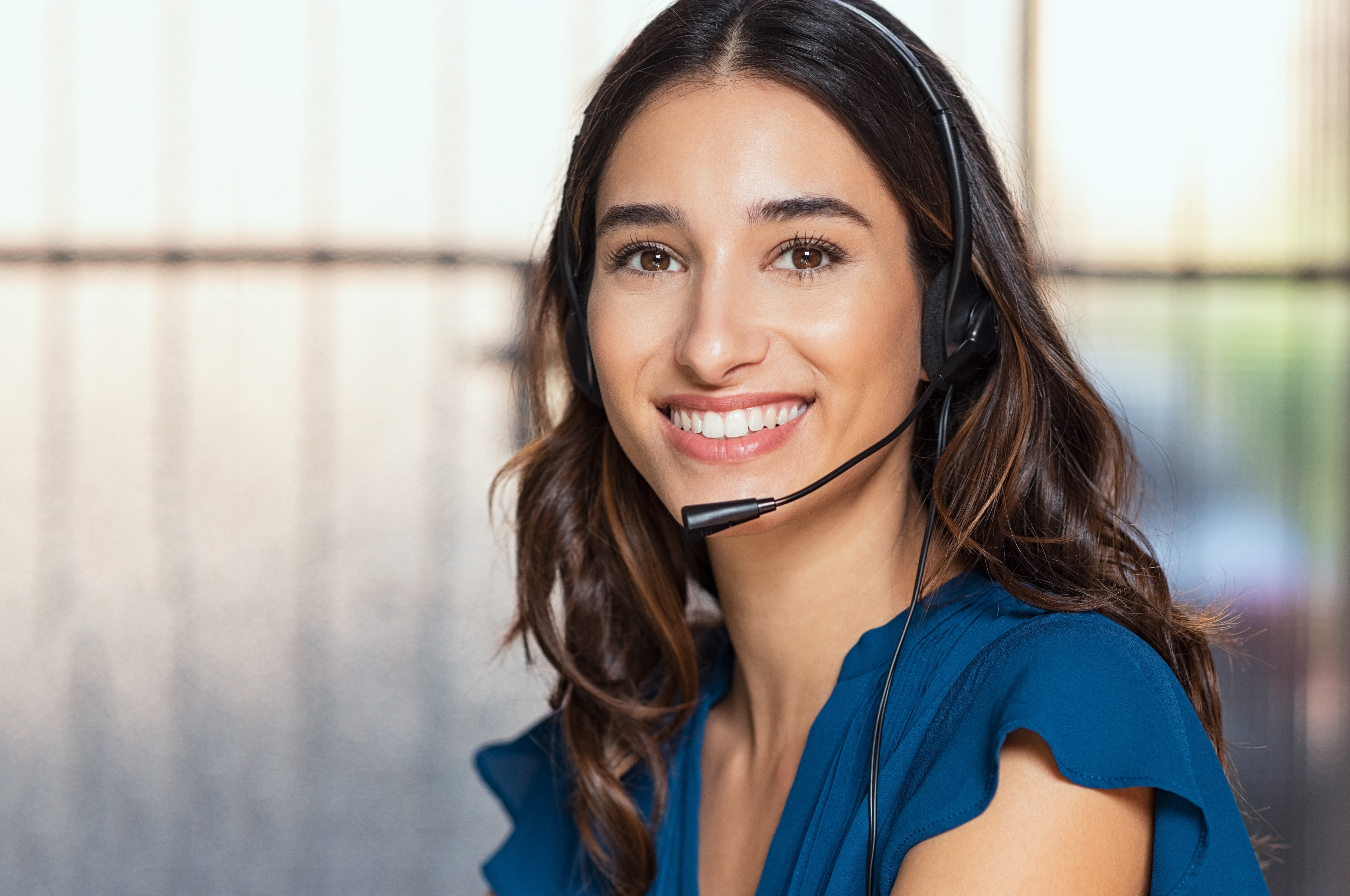 Woman with a head set on ready to help customers with their services