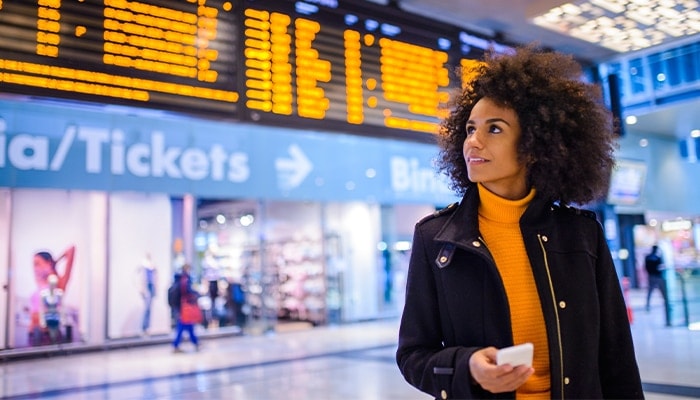 woman using mobile phone in airport